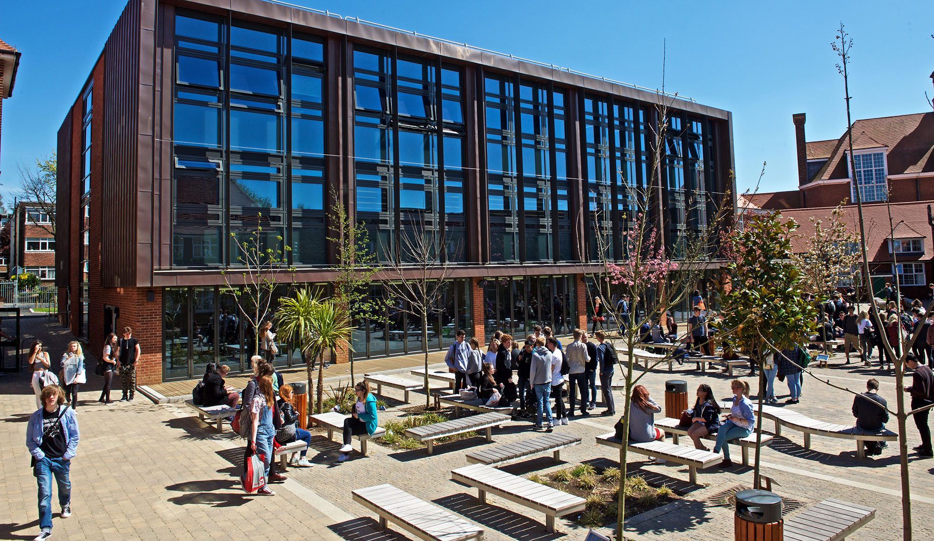 Students gathered among CHRONOS Benches in a courtyard